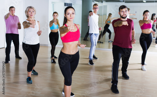 positive active sporty adults of different ages dancing at dance class