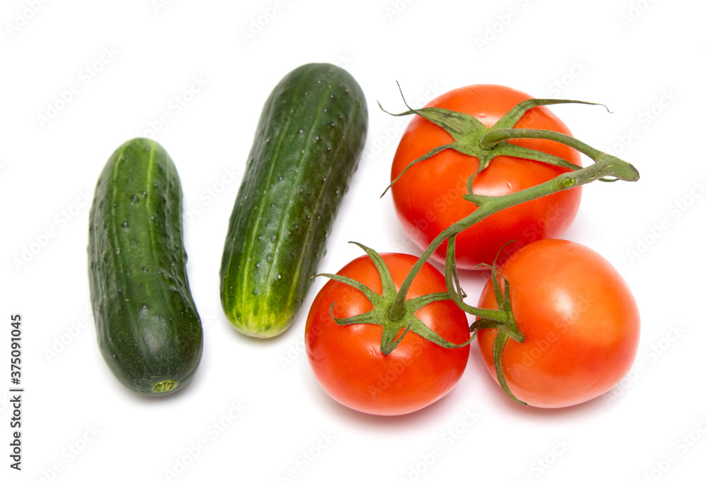 Red tomato and green cucumber isolated on a white background. Red tomato and green cucumber isolated on a white background.