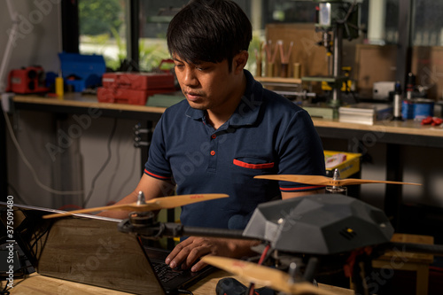Engineer developing on drone in workshop.