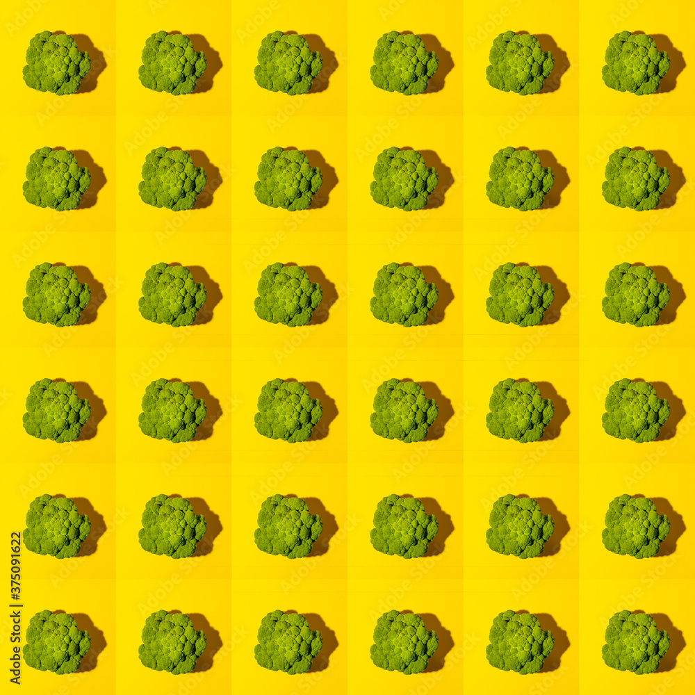 Fototapeta premium Seamless pattern of top view ripe juicy green head of broccoli cabbage on bright yellow background.
