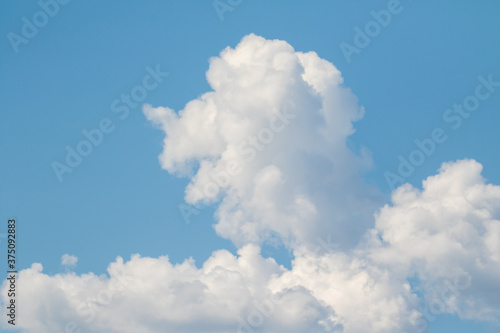 White large cumulus clouds against the blue sky.