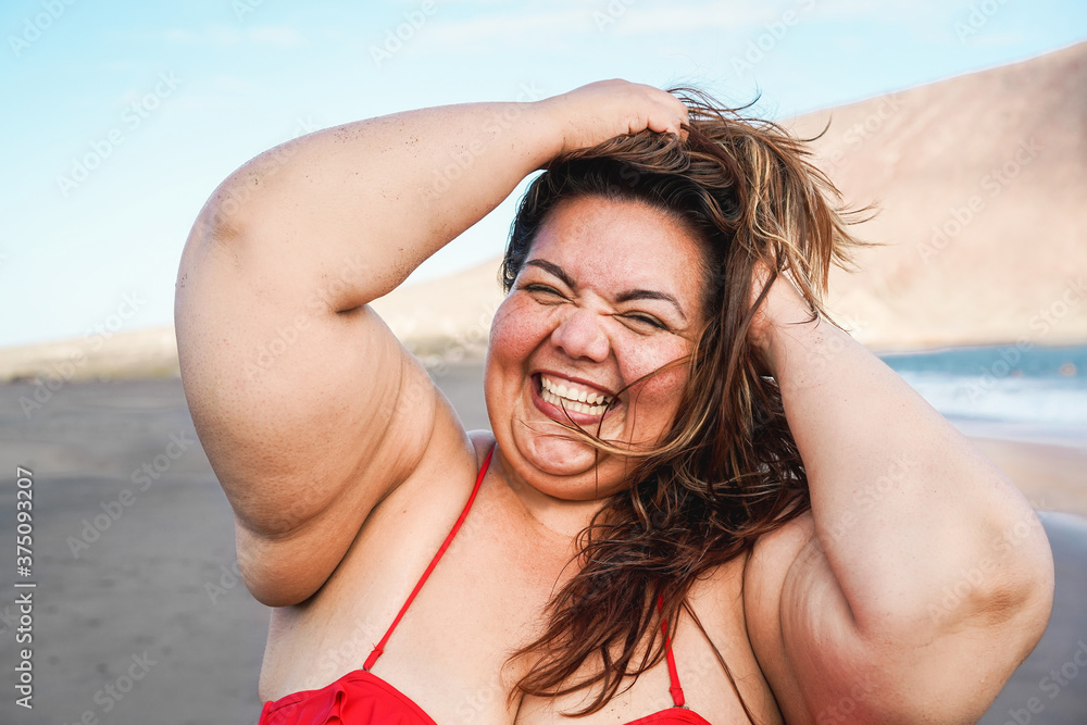 twijfel genezen plakband Happy curvy woman smiling on camera wearing bikini with beach in background  - Plus size person and overweight female body concept Stock Photo | Adobe  Stock