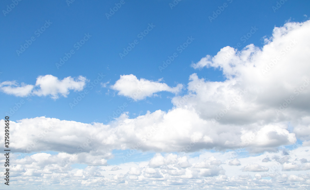 White clouds on a background of blue sky, landscape.