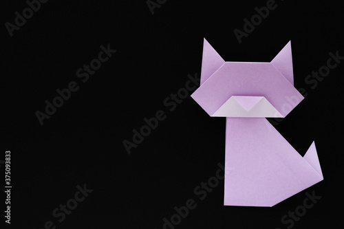 light purple origami cat on black background