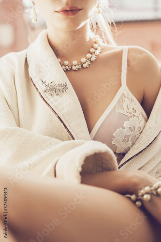 Sexy woman in white lace bra and jewelry