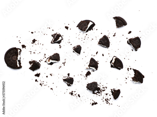 Sandwich chocolate cookies with a sweet cream with crumbs isolated on white background.