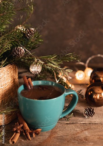 Open book with folded sheets in heart shape and cup of tea in bed with Christmas lights closeup. Good morning. Breakfast time