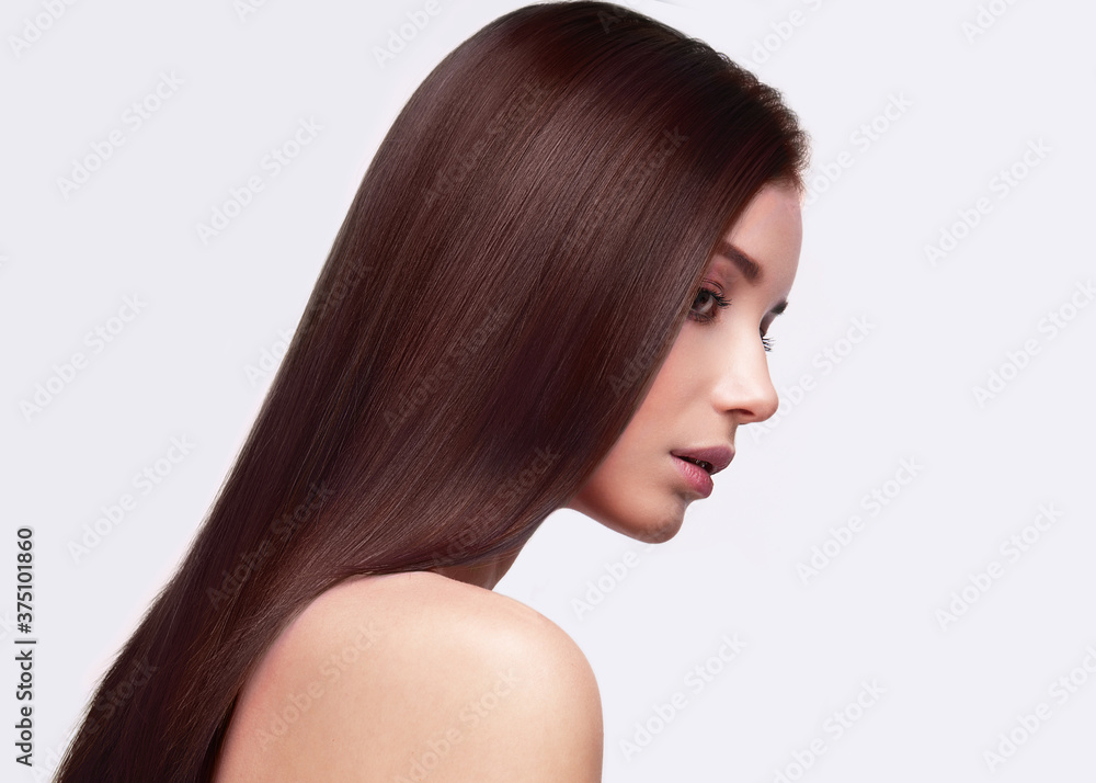 Portrait of beautiful brown-haired woman with a perfectly smooth hair, and classic make-up Portrait of beautiful brown-haired woman with a perfectly smooth hair, and classic make-up