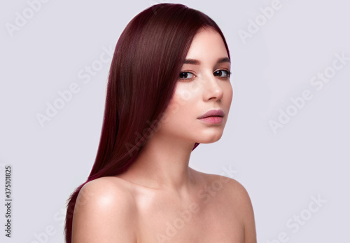 Portrait of beautiful brown-haired woman with a perfectly smooth hair, and classic make-up