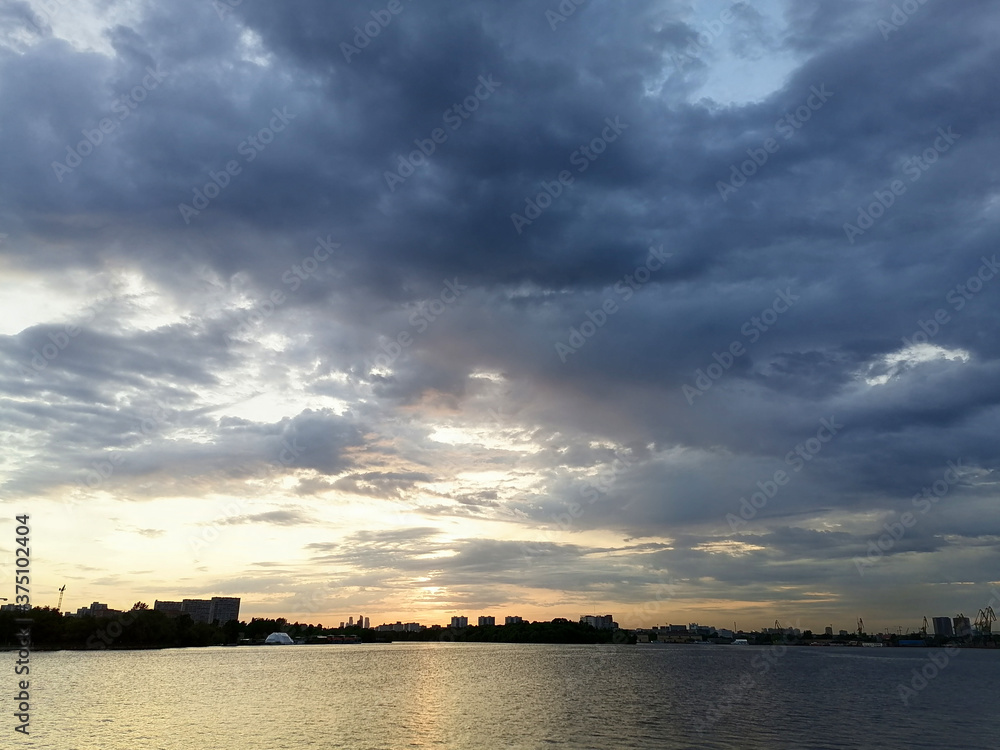 Beautiful sunset with the original clouds and the quiet water