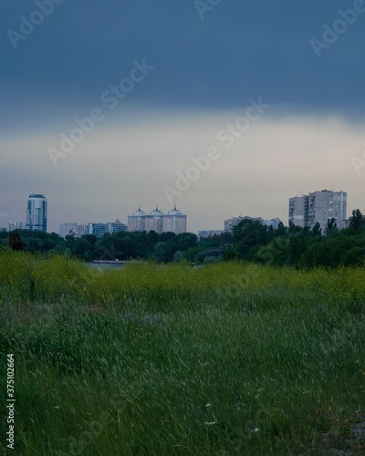 city skyline at sunset, sky and dark blue clouds © Евгенія Борунова