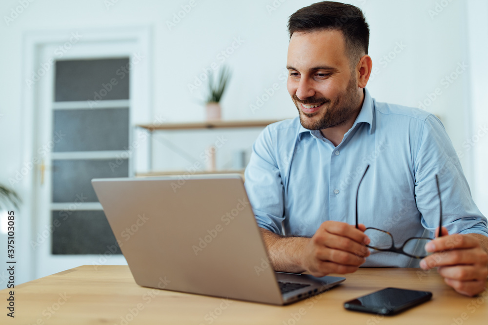 Using laptop at home office. Using laptop at home office.