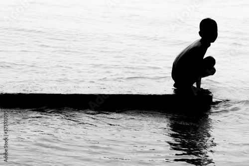 Εκτύπωση καμβά A village boy bathing on river water and having fun