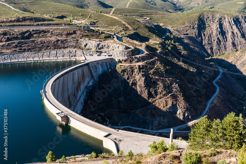 The Atazar reservoir and dam in a mountain range photo