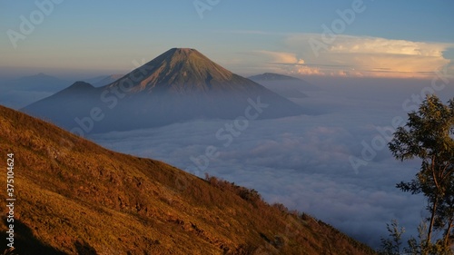 Mount Sindoro seen from the slopes of Mount Sumbing in the morning where thick clouds still lay covering the view down © Bari