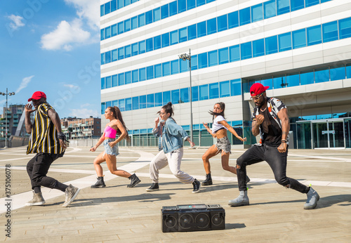 Fototapeta Hip hop crew dancing outdoors