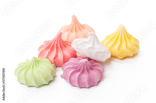 Foto Pile of colorful meringue cookies isolated on white