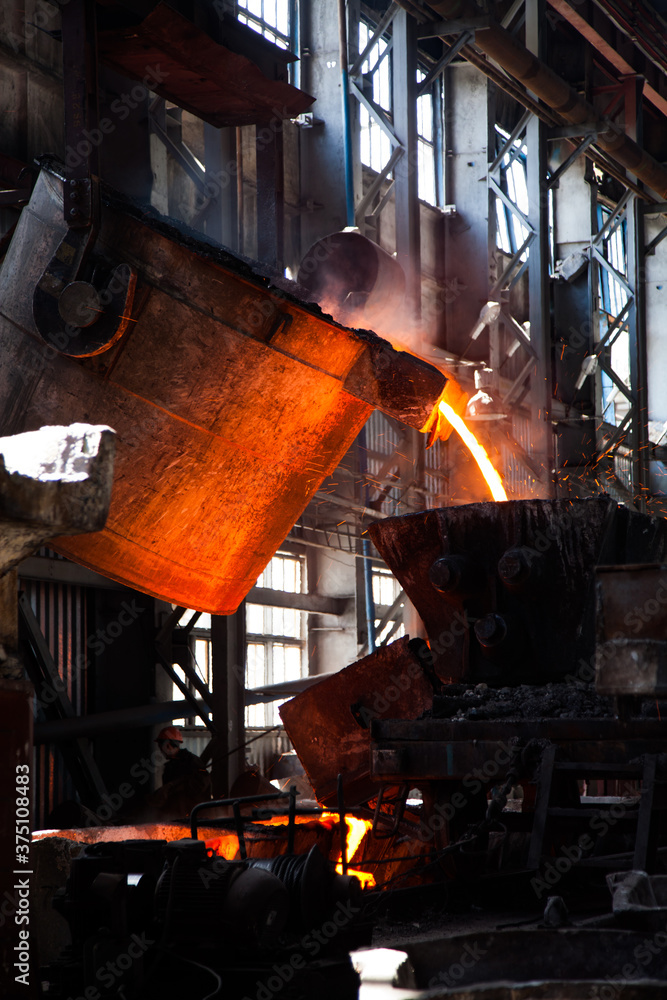 Metallurgy plant interior. Melting of metal. Metallurgy bucket with liquid hot melted metal. Kazakhstan, Taraz city.
