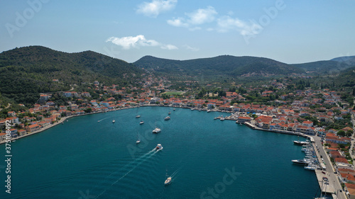 Aerial drone photo of picturesque village capital and port of Ithaki or Ithaca island a safe anchoring for sail boats featuring small islet of Lazareto with small chapel built on it, Ionian, Greece
