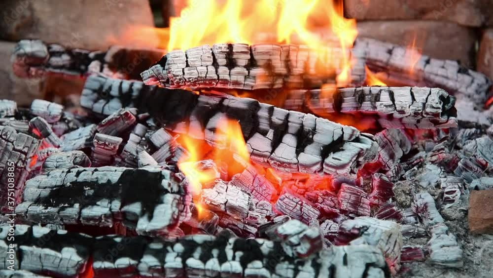close up bonfire flames of camping fire. brazier for a barbecue made of bricks. Summer evening. close up bonfire flames of camping fire. brazier for a barbecue made of bricks. Summer evening.
