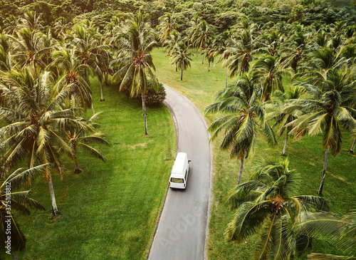 Canvas Print High angle view of a small camper driving through tropical landscape
