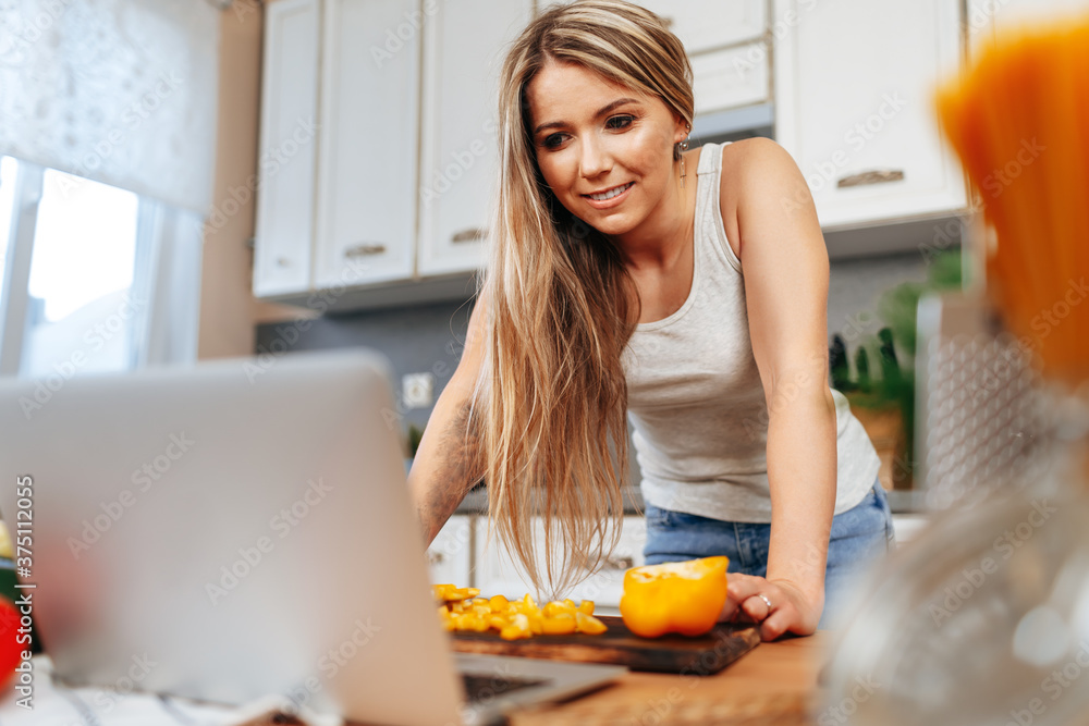 Young pretty woman cooking something in her kitchen Young pretty woman cooking something in her kitchen