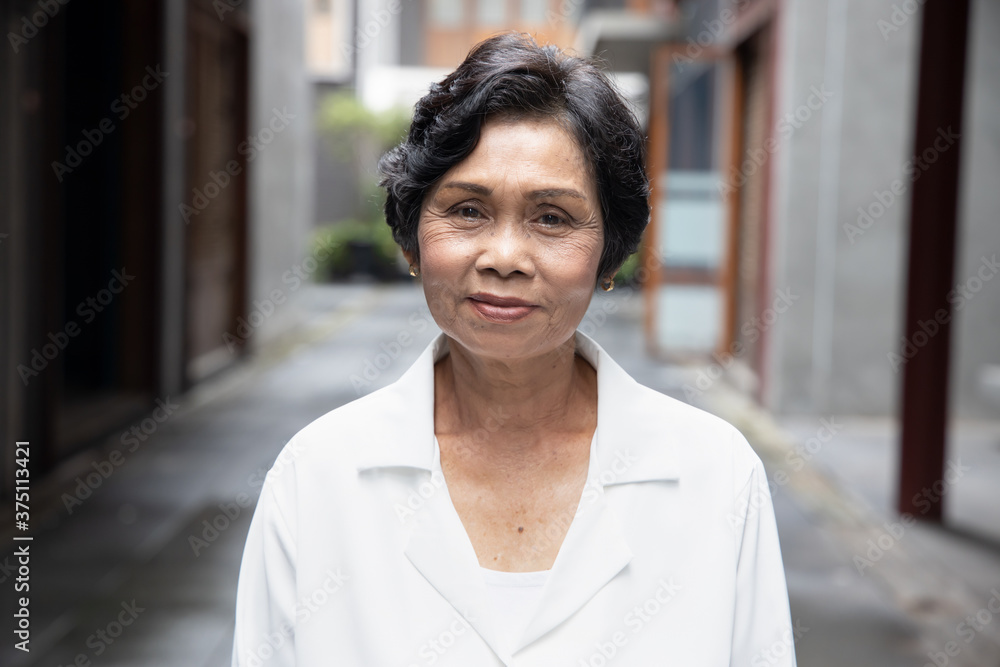 portrait of old Asian senior woman with wrinkle skin and black