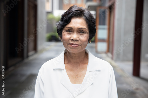 Obraz na plátně portrait of old Asian senior woman with wrinkle skin and black dyed hair