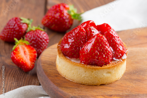 Mini tart with strawberries close up. Berry dessert