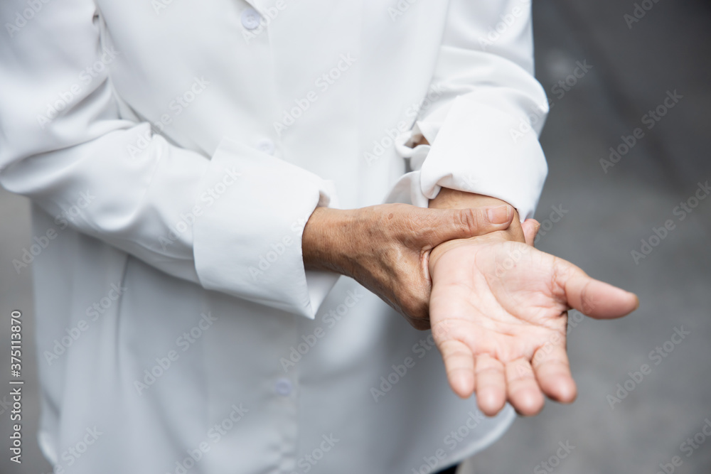 old asian senior woman suffering from trigger finger, cps or carpal tunnel syndrome, gout disease, arthritis inflammation old asian senior woman suffering from trigger finger, cps or carpal tunnel syndrome, gout disease, arthritis inflammation