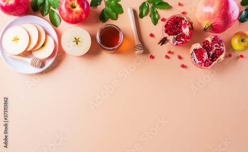 Rosh hashanah (Jewish New Year holiday), Concept of traditional or religion symbols on pastel orange paper background. photo