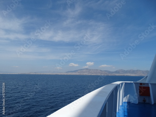 Ferry is approaching port of Athens, Piraeus, in Greece main land. Seascape and cityscape from a moving vessel in the Mediterranean Sea. Way to Athens from Santorini, sea way transportation. © isparklinglife