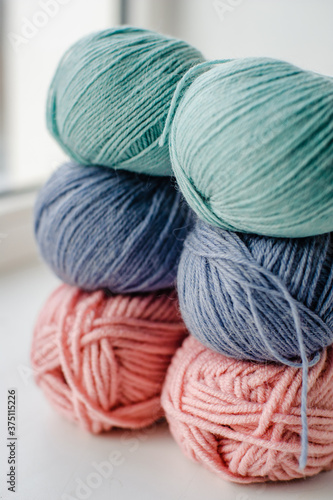 Multicolored skeins of wool yarn. Alpaca, Merino yarn. Threads for knitting and crocheting. Creativity and Hobbies