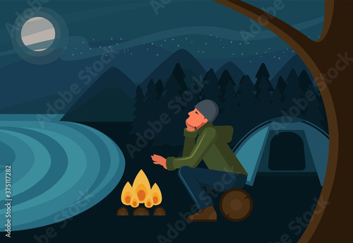 The man warms his hands and the fire and looks at the starry sky. Tourist in a campsite. Outdoor recreation. Flat design. Vector illustration.