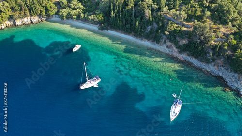Aerial drone top down photo of sail boats anchored in small port of Frikes, Ithaki or Ithaca island, Ionian, Greece photo