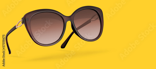 Retro female sunglasses isolated on yellow background