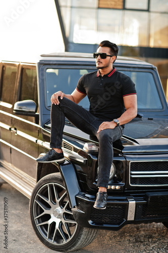 Asian man wear on all black posed near suv car. © AS Photo Family