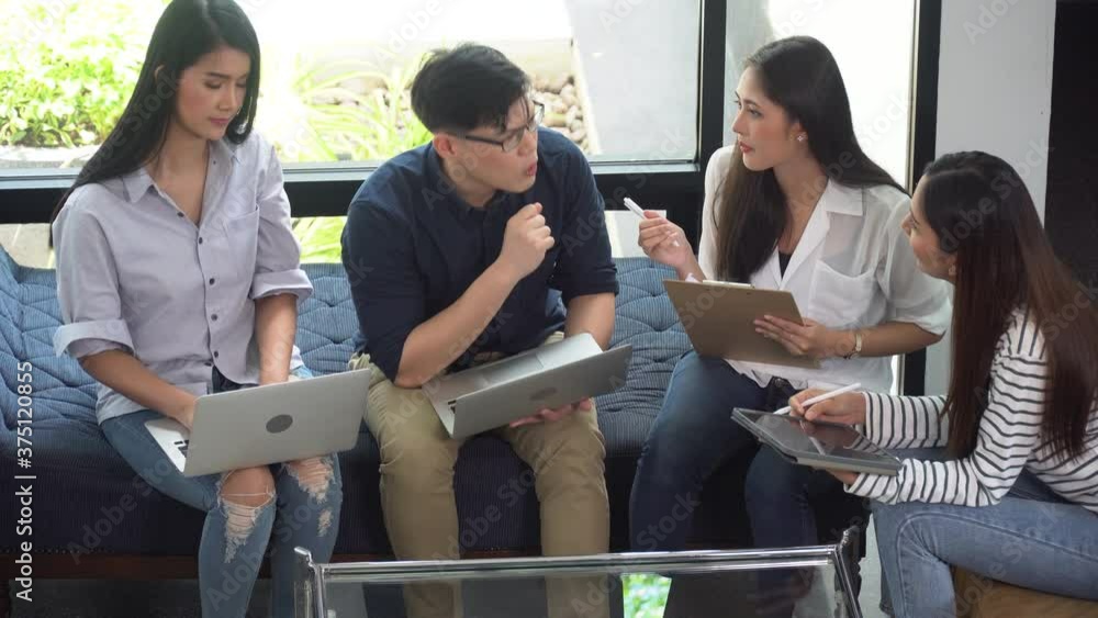 group of young asian business people team meeting sitting on sofa at ...