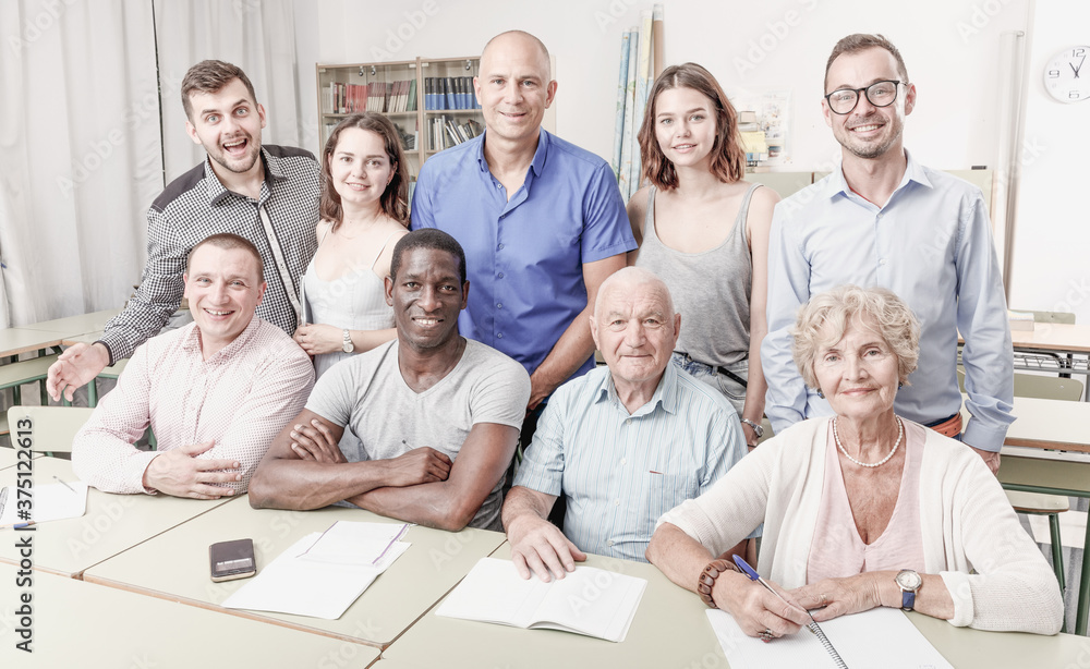 Fototapeta premium Portrait of group students different ages in modern classroom