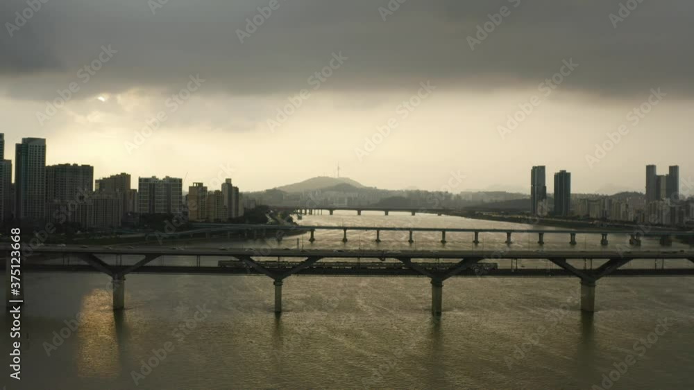 Still Drone shot of a train crossing in Seoul, South Korea on a Cloudy day Still Drone shot of a train crossing in Seoul, South Korea on a Cloudy day