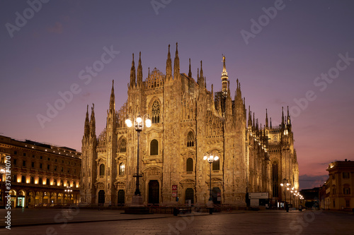Fototapeta Naklejka Na Ścianę i Meble -  View of the beautiful high Duomo at night. Against the background of a beautiful sunset. Milan, Italy. 22.08.2020