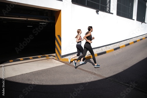 Fit women in sport clothing jogging outdoors and living a healthy lifestyle.