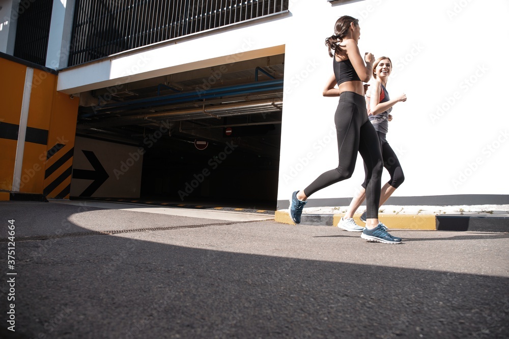 Fototapeta premium Fit women in sport clothing jogging outdoors and living a healthy lifestyle.