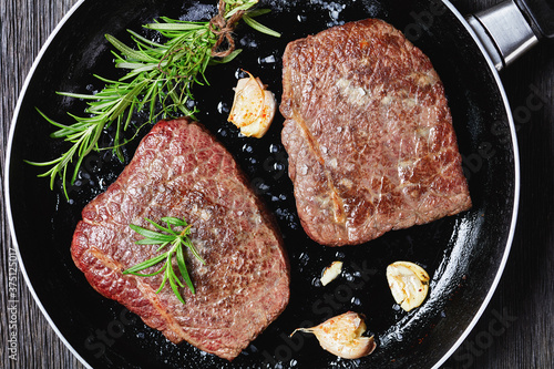 fried rump beef steaks in a skillet photo