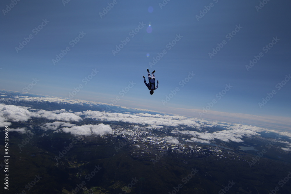 Skydivers over snowy mountains in Norway Skydivers over snowy mountains in Norway
