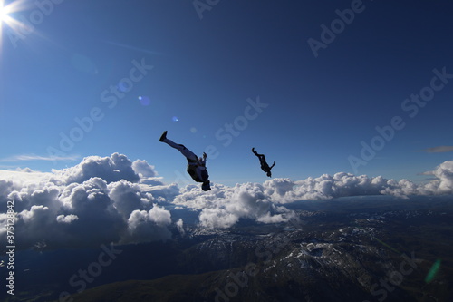 Skydivers over snowy mountains in Norway © sindret