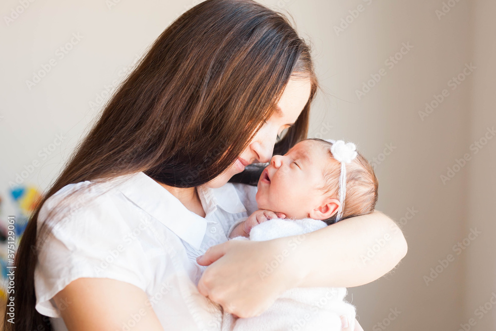 Family, happy childhood and maternity concept. Indoor shot of attractive young European mother Family, happy childhood and maternity concept. Indoor shot of attractive young European mother