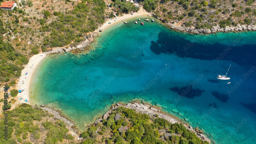 Aerial drone photo of turquoise heart shaped paradise sandy beach and bay of Sarakiniko a safe sail boat anchorage in Ithaki or Ithaca island, Ionian, Greece
