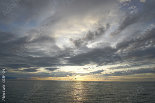 Sunset. Beautiful sunset at Japanese sea. Gold cloudy sky sunset. Picture Sea sunset.