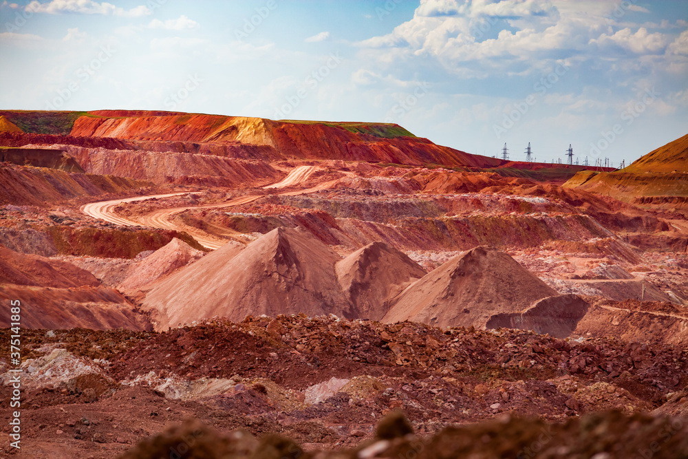 Aluminium ore quarry. Bauxite clay open-cut mining. Heaps of empty rocks and ore. Aluminium ore quarry. Bauxite clay open-cut mining. Heaps of empty rocks and ore.
